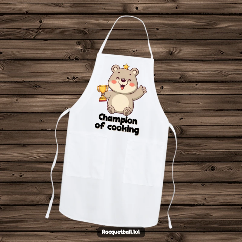 Funny apron showcasing a proud bear character holding a tiny trophy after scoring a point, combining kitchen wear with humorous sports celebration.