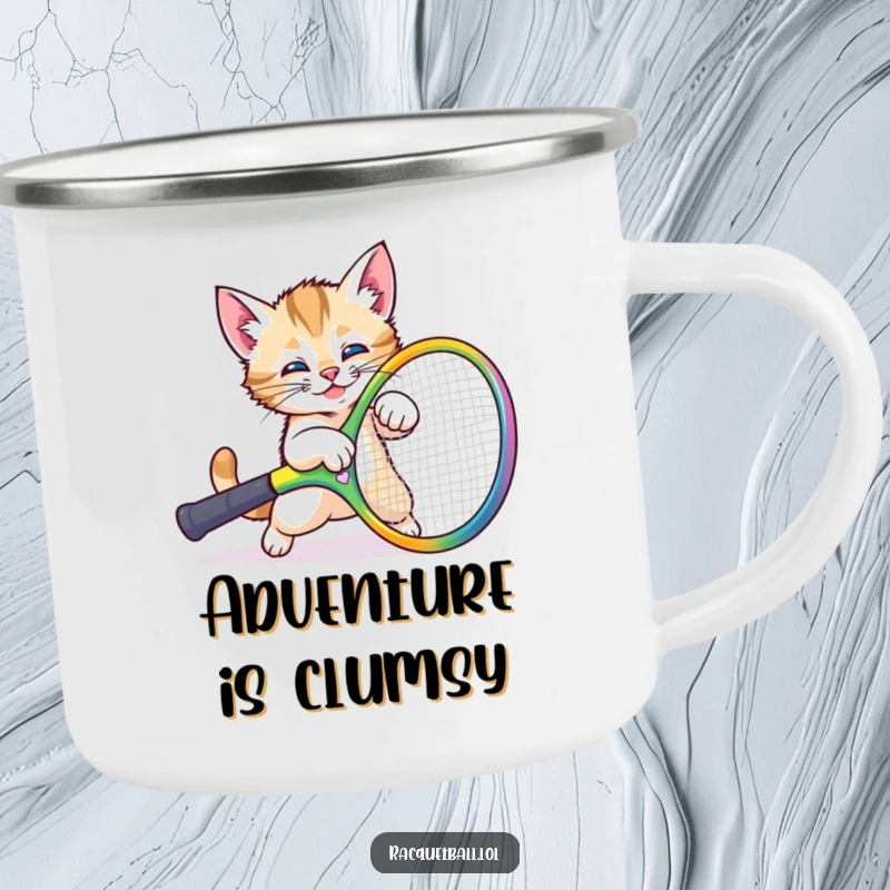 Funny kitten camp mug showing a cute cat comically tripping over a large tennis racquet, perfect for enjoying drinks outdoors.