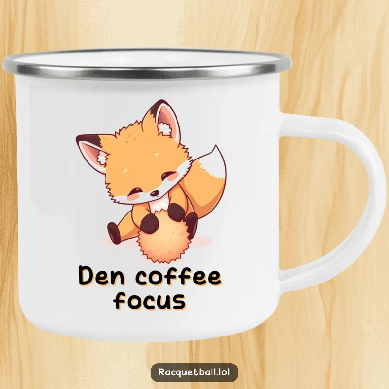 Funny camping mug showing a playful fox cub sliding dramatically to return a tiny, fuzzy ball, outdoor adventure.