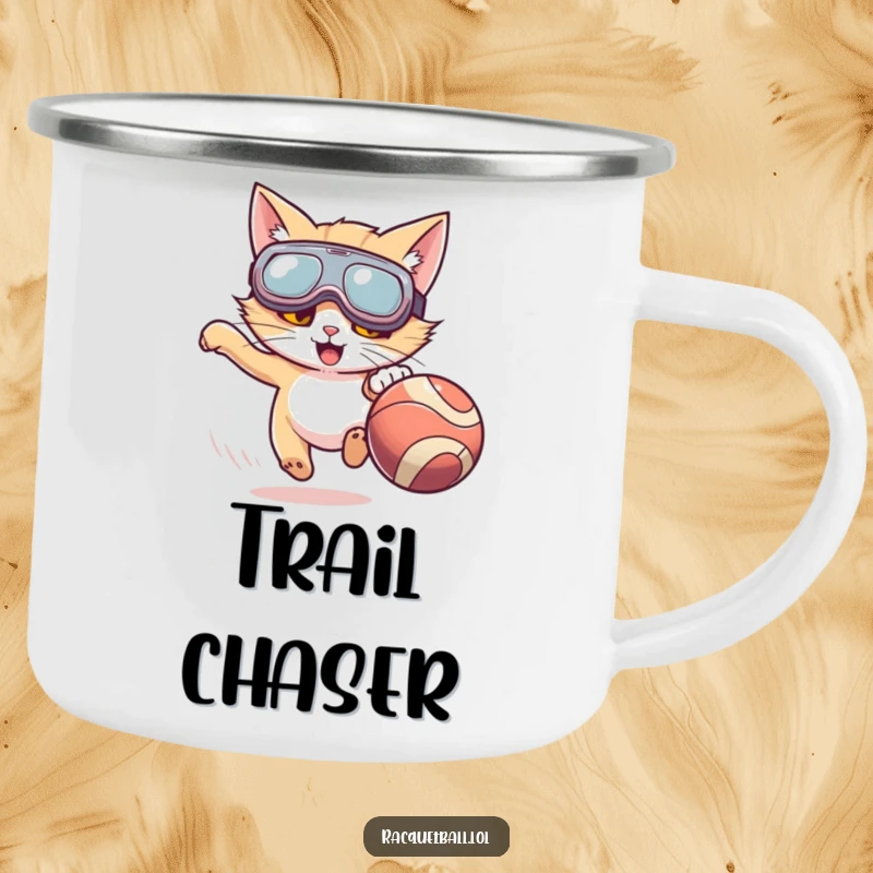 Funny camping mug with a cat wearing oversized goggles enthusiastically chasing a fast-moving ball, bringing playful energy to trips.