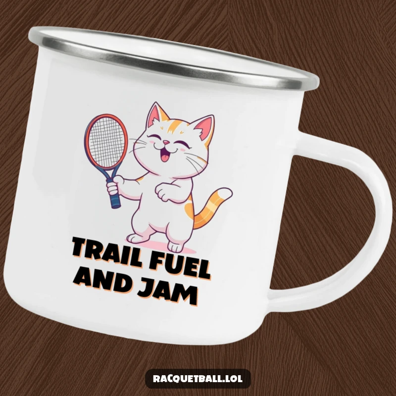 Funny cat camping mug featuring a joyful cat with a racquetball racquet, celebrating victory with intense glee in an outdoor setting.