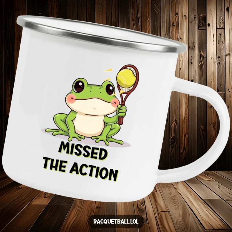 Funny camping mug with a frog intently watching a fast racquetball zoom by, a humorous and durable choice for outdoor observation.