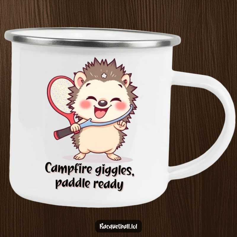 Funny camping mug with a small, giggling hedgehog holding a comically oversized racquetball paddle, perfect for trailside brews.