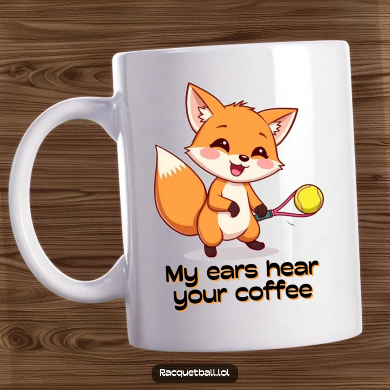 Funny mug with a happy fox wiggling ears, expertly catching a bouncing racquetball, showcasing pure joy and gaming enthusiasm.