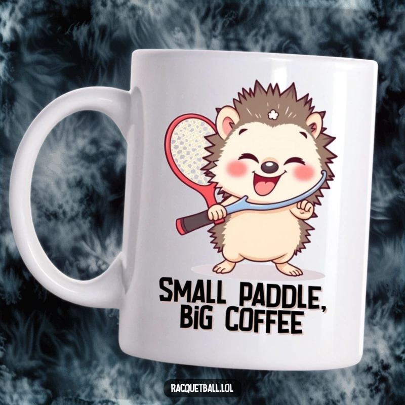 Funny mug featuring a small hedgehog giggling gleefully while holding a comically oversized racquetball paddle, ready for action.