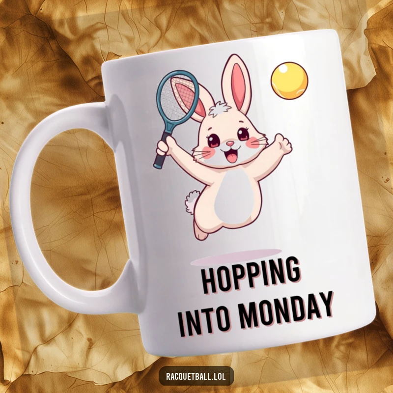 Funny rabbit tennis mug showing a fluffy, excited bunny leaping with a racquet raised to hit an unseen ball.