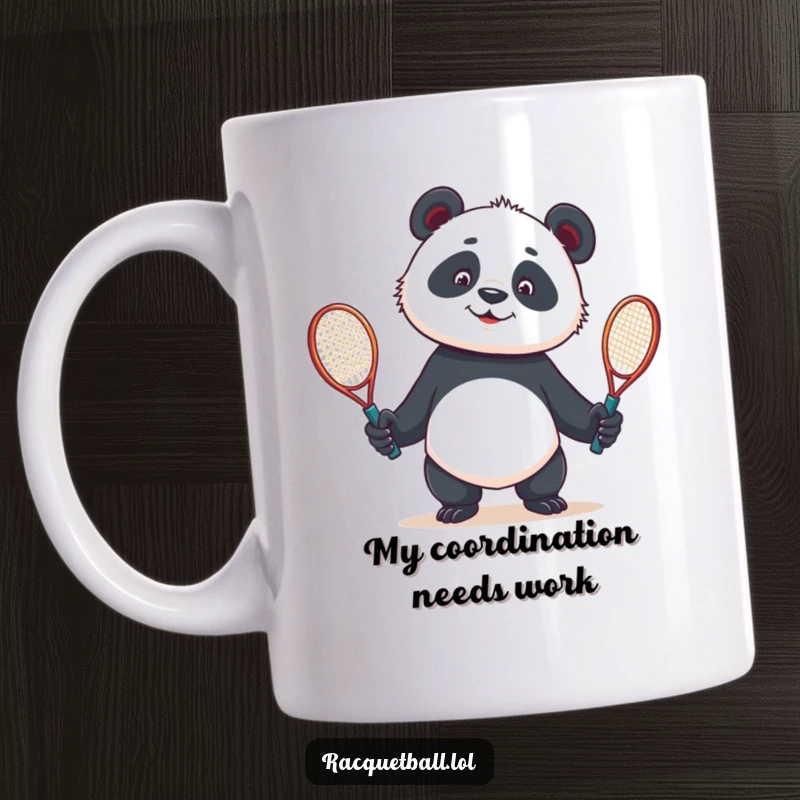 Funny mug showcasing a curious panda comically juggling two tennis racquets, expressing playful confusion and love for the sport.