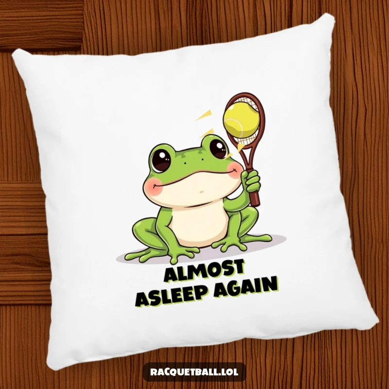 Funny pillow featuring a frog with wide eyes watching a racquetball speed past, adding soft, humorous surprise to any decor.