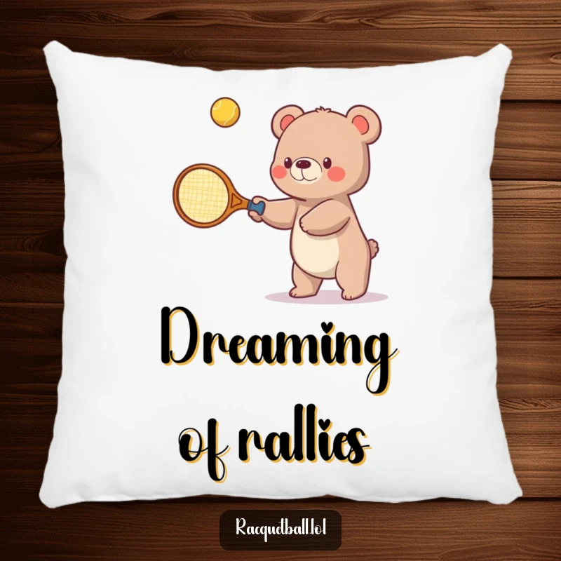 Funny pillow with a small bear humorously holding an oversized tennis racquet, focusing intensely on batting a bouncing ball upwards.