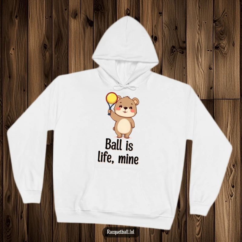 Funny Hoodie: Curious bear character proudly holding a tiny racquetball, offering a warm and humorous design.