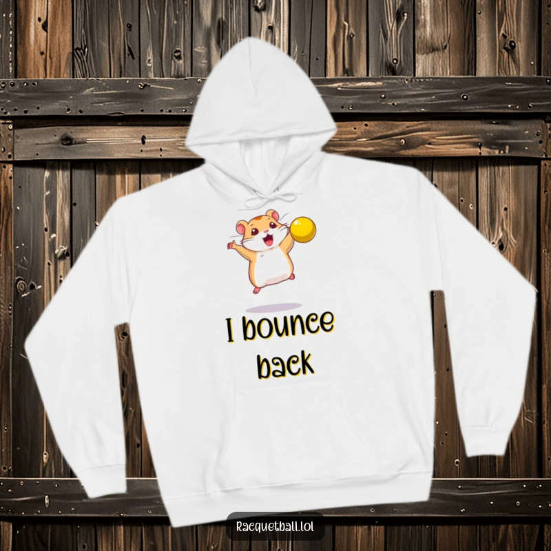 Funny hoodie design of a determined hamster leaping to smash a bright yellow ball, symbolizing power.