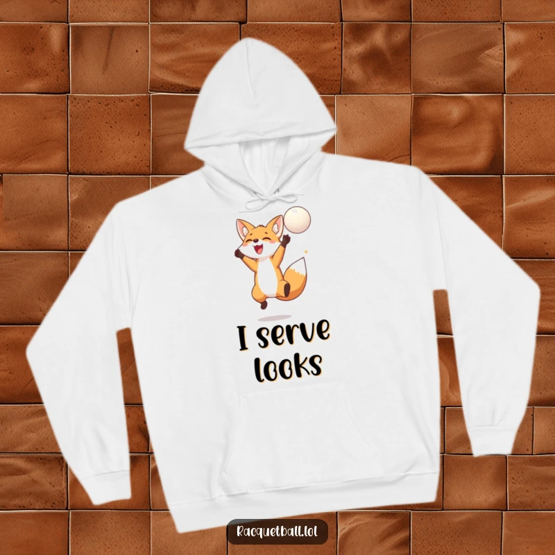 Funny fox hoodie showcasing a delighted fox jumping high to hit a floating ball, radiating playful energy and woodland charm.