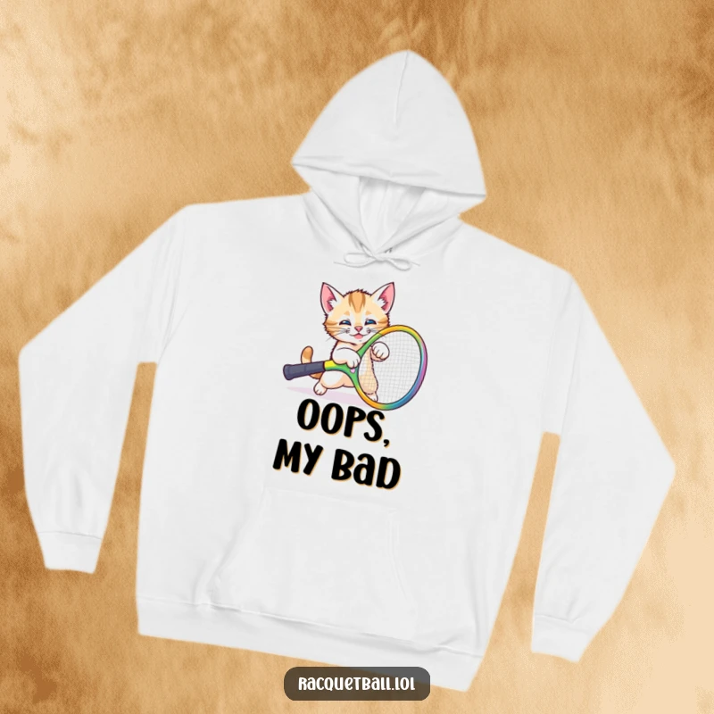 Funny kitten racquet mishap hoodie featuring a comical cat tripping over a giant colorful tennis racquet, perfect for cozy laughs.
