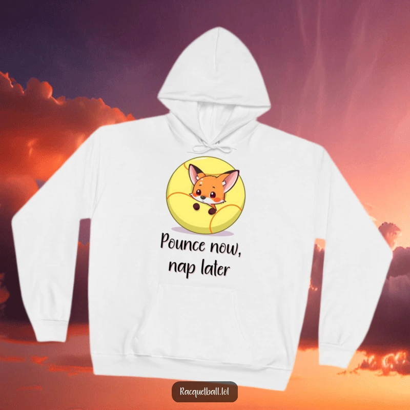 Funny fox hiding behind a massive racquetball, about to strike, printed on a warm and funny hoodie.