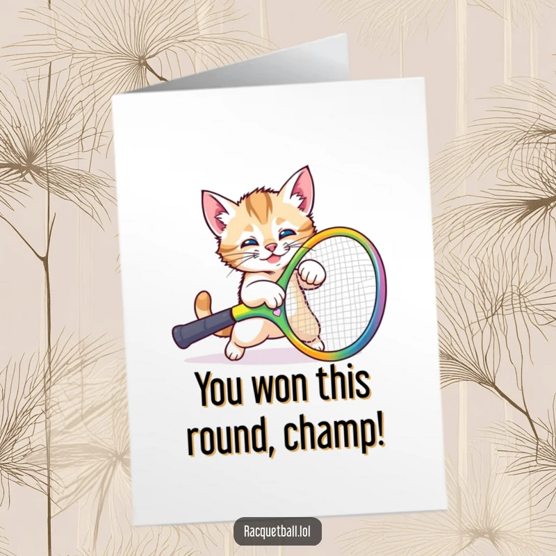 Funny Free Printable Congratulations Card: A playful kitten comically trips over a huge colorful racquet, tumbling with surprise and delight.