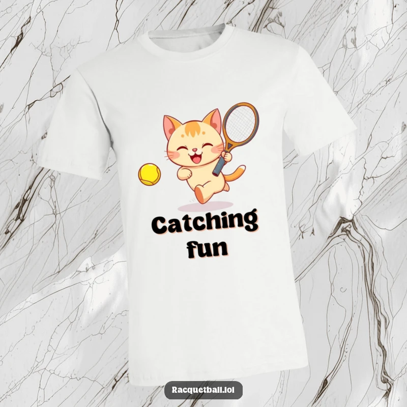 Funny Cat Tennis T-Shirt showing a happy cat bounding after a brightly colored ball with a tennis racquet, full of energy.