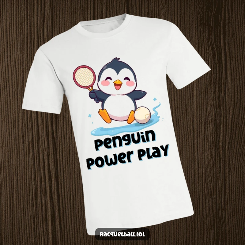 Funny t-shirt with a happy penguin comically sliding into a tennis ball, showcasing athletic fun and determination.