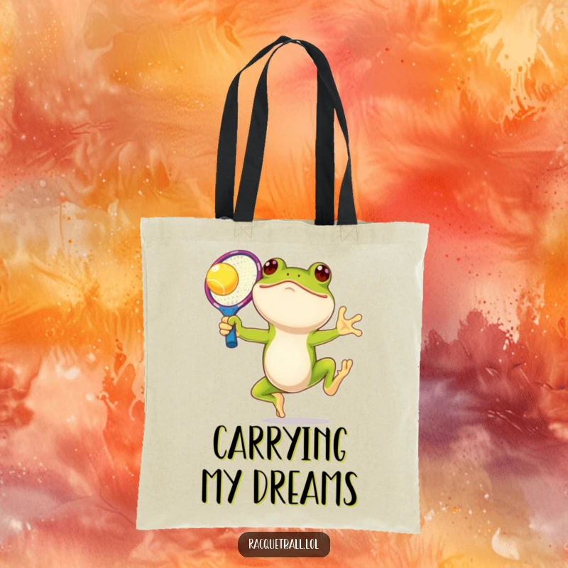 Funny frog tennis tote bag, a smiling amphibian leaping with an oversized, colorful racquet, perfect for carrying essentials with playful charm.