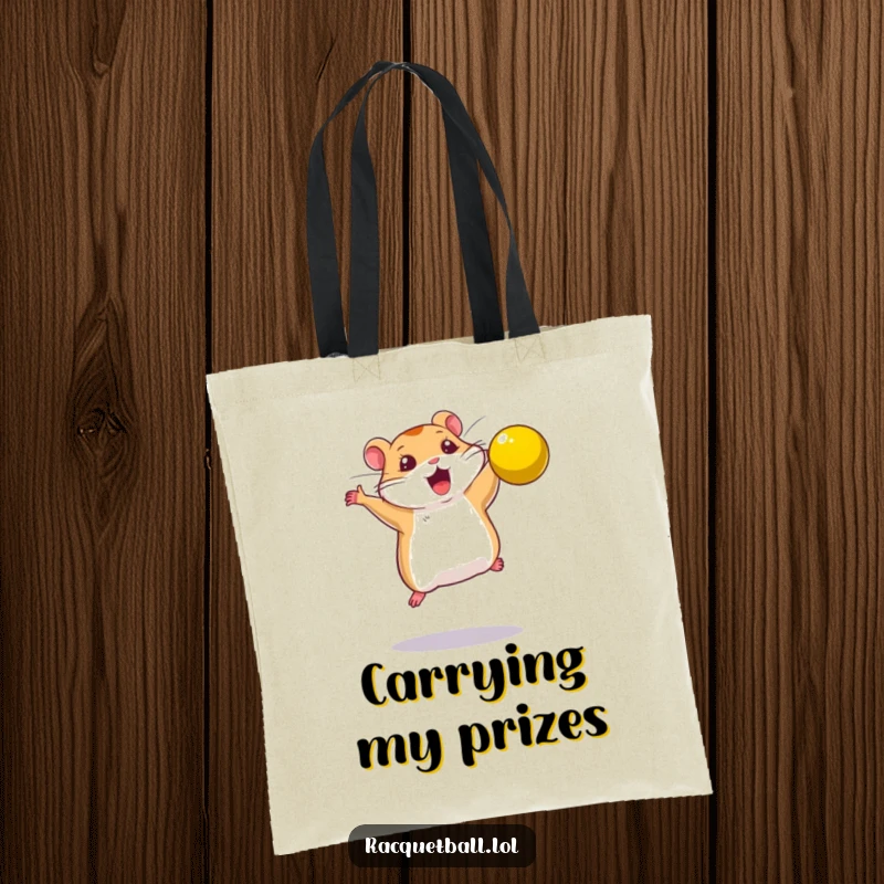Funny tote bag showing a determined hamster leaping to smash a bright yellow ball, ready for action.