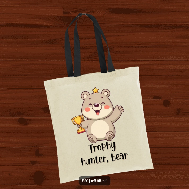 Funny tote bag featuring a proud bear character holding a comical tiny trophy after scoring a point, perfect for carrying gear with humor.
